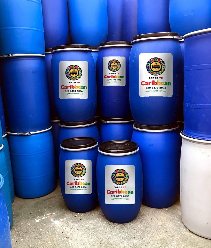 Stacks of blue shipping barrels with Cargo to Caribbean labels